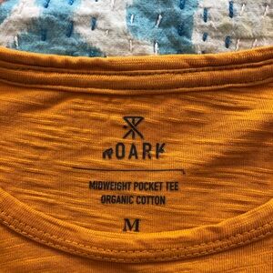 Roark Meduim t shirt. Orange with gray stitching.